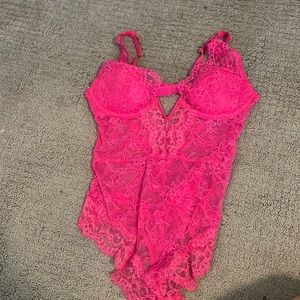 Small, bright pink bodysuit. Can be worn as lingerie or a going out top.